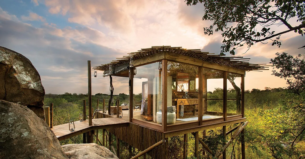 Glass-walled treehouse suite on a granite outcrop above the bushveld